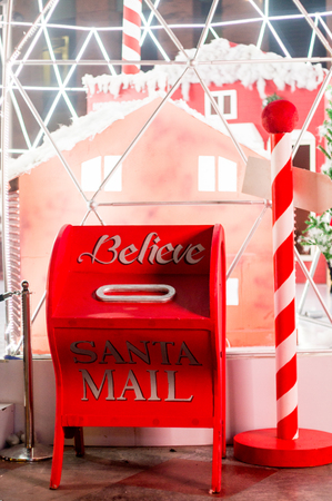 letter box for santa's mails set to a background of candy canes and houses