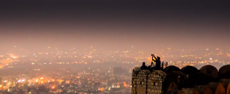 Jaipur: India; 30th Dec 2014 - Photographer using tripod to take photos of Jaipur city from Nargarh fort. The fort is a popular tourist destinationのeditorial素材