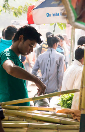 Delhi India 7th Jun 2015: Vendor running a sugarcane juice business in Gurgaon Delhi India. Such roadside stalls are extremely popular in the hot summersのeditorial素材