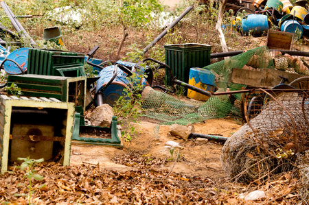 Discarded junk thrown together rather than being reused or recycled. Covered with dead leaves and junkのeditorial素材