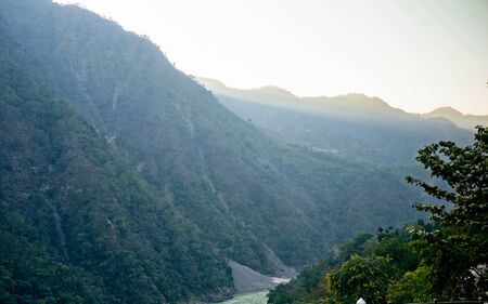 Himalya mountain range with the deep light of the morning shining on the plant covered hillsの写真素材