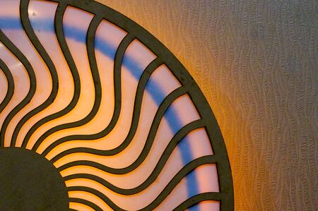 Wooden design of two circles connected by wavy lines and lit by colorful lights. Can denote the circle of life, karma, the mstical divine connectionsの写真素材