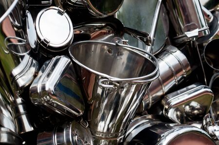Shiny new metal utensils and items lying together. These items are traditionally purchased on the hindu festival of Dhanterasの写真素材