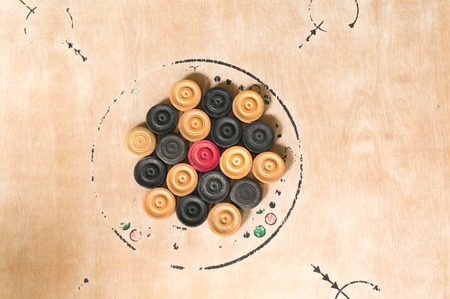 Carrom men arranged on the board for a game. This is a very popular table game played in India and east asiaの写真素材