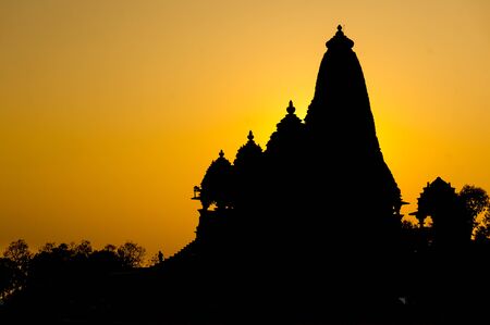 Evening silhouette of the temples in Khajurao, India. These beautiful temples are a  site and a top tourist destinationの写真素材