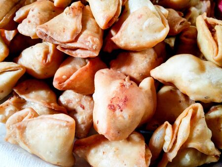 Closeup of indian snack of samosas. These are hot pockets filled with boiled spicy potatoes and...