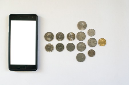 Arrow of coins from mobile phone. Mobile phone with indian currency set on a white background. Denoting payment through mobile and mobile walletsの写真素材
