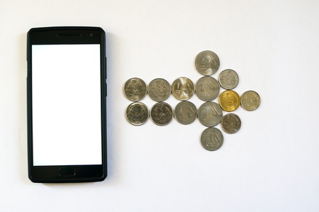Arrow of coins from mobile phone. Mobile phone with indian currency set on a white background. Denoting payment through mobile and mobile walletsの写真素材