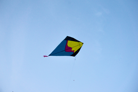 Handmade fighting kites flying against blue skyの写真素材