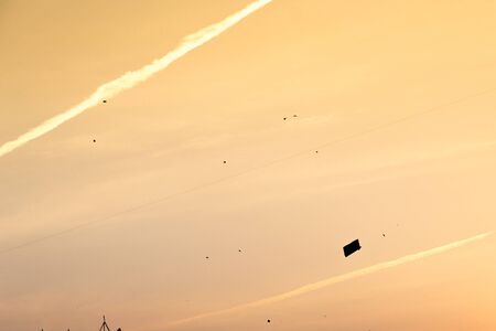 silhouette of kite against orange sky