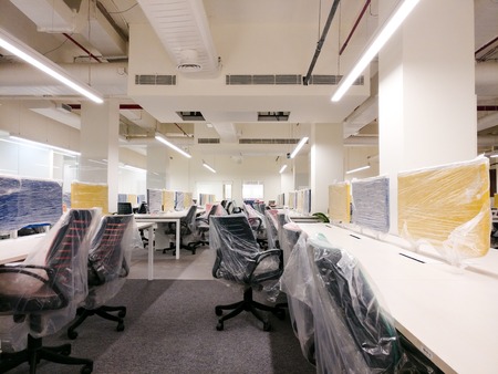 colorful new office with the plastic covers still on the furnitu