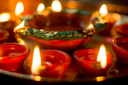 Macro shots of diyas being lit on Diwali in india