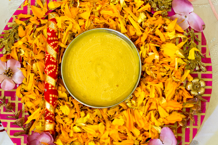 Traditional Haldi turmeric kept on a flower plate for the hindu marriage ceremonyの写真素材
