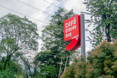 Broken cafe coffee day logo surrounded by trees ourdoorsのeditorial素材