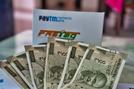 Gurgaon - India, Circa 2019: Photograph of Fast Tag provided by PayTM pament bank on a beautifully crafted table along with currency notes. Fast tag is expected to make toll stops cash and hassle free and was implemented on 15th December 2019のeditorial素材