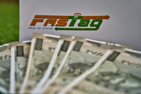 Gurgaon - India, Circa 2019: Photograph of Fast Tag on green grass along with currency notes Fast...