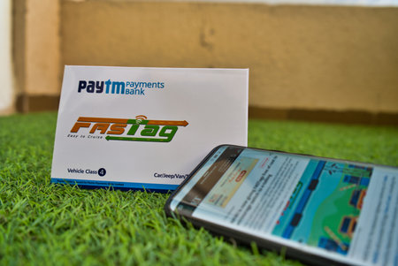 Gurgaon - India, Circa 2019: Photograph of Fast Tag provided by PayTM Payment Bank on green grass...