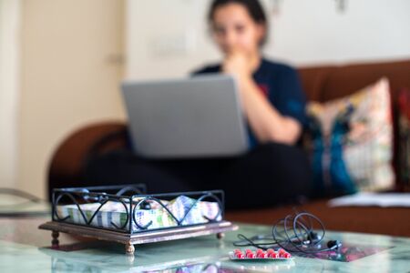 Young indian girl woman working from home with a laptopの写真素材