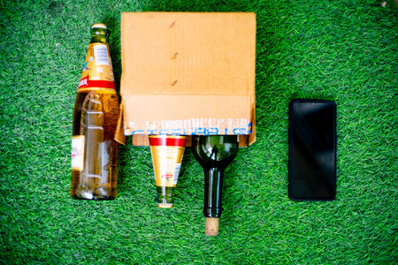 Gurgaon, Delhi, India - circa 2020 : Alcohol in a cardboard box with beer and wine home delivered through online app shot in a garden at home. Concept on government guideline on home delivery of alcohol liquor amidst the coronavirus pandemic lockdownのeditorial素材