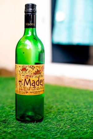 Gurgaon, Haryana, India - circa 2020 : Bottle of alcohol liquor wine beer placed on grass in home garden showing home picnic with home delivered alcohol in coronavirus pandemic. Concept for opening up of restrictions of alcohol sale in India due to the coのeditorial素材