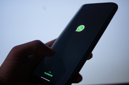 A mobile logged into the Whatsapp mobile application infront of the white screenのeditorial素材