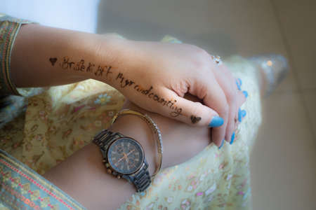 Young indian girl decked in white gold dress preparing for a wedding words bride to be BFF written...