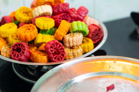shot of colorful Fryums being deep fried in hot oil bubbling and sizzling with bubbles forming and size increasing of this popular north indian snack and street food. This sago and potato starch delicacy is a popular snack that is unhealthy but very tastyの写真素材