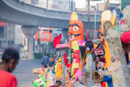 Street road side artisans workers labor craftsment working on multiple paper effigy statues of ravan...