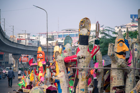 Street road side artisans workers labor craftsment working on multiple paper effigy statues of ravan the demon king who is burnt on the hindu festival of dussera as foretold in the ramayana.のeditorial素材