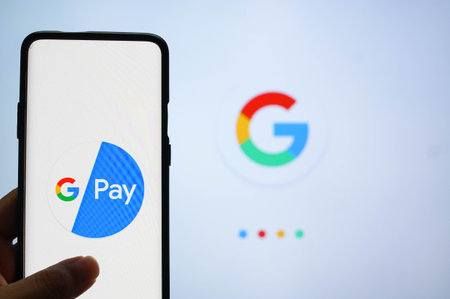 Google Pay app logged in on a mobile infront of a white screen with Google symbolのeditorial素材