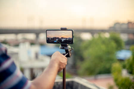 Mobile phone mounted on a tripodの写真素材