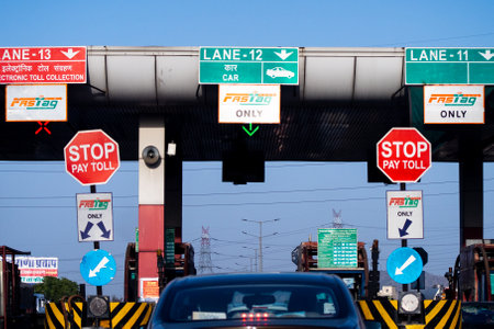 wide angle shot of toll booth in india with the Fast tag FASTag signs on all lanes showing the...