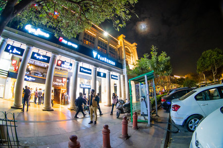 Fisheye wideangle shot of the famous landmark connaught place with colorful lights, white pillars and arches and colorful lights all around them but low crowds due to the coronavirus pandemicのeditorial素材