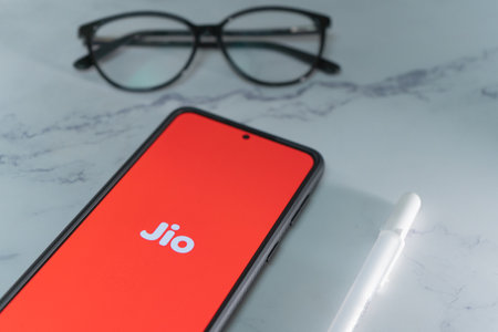 mobile phone with reliance jio logo in red showing indias largest internet service provider ISP which has changed how data is used in the country and jumped in stock priceのeditorial素材