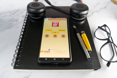 mobile phone app with the NPS national pension scheme app showing the mandatory investment and saving for indian workers for retirement annuity and incomeのeditorial素材