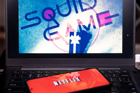 Laptop screen showing the very popular korean drama series squid game on netflix which has become a best seller, cryptocurrency and is renewed for a second seasonのeditorial素材