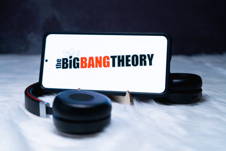 mobile smartphone on stand with headphones near it placed on a fur snow surface binge watching Big Bang Theory popular netflix showのeditorial素材