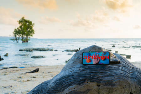 mobile phone placed on a rock at a deserted beach under lockdown due to the omicron COVID variant...