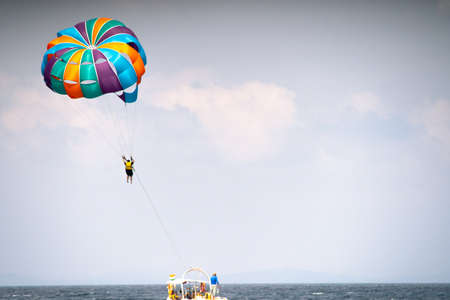 multiple boats in distance doing para gliding sailing while adventure sports like jet sking...