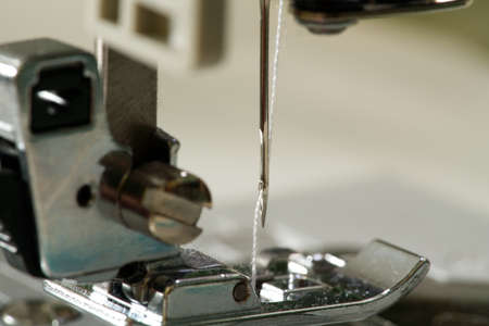 Sewing machine with focus on needle, shallow depth of field