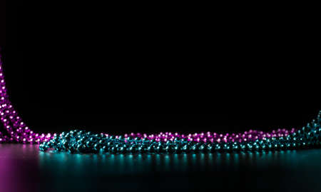 green and violet beads on a dark backgroundの写真素材