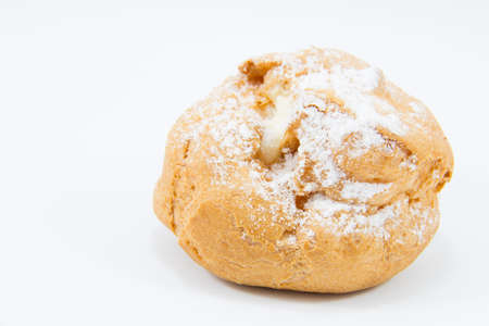 Sweet brown cream choux with icing on a white background.の写真素材