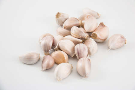 Pile of garlic bulb isolated put on a white background.の写真素材