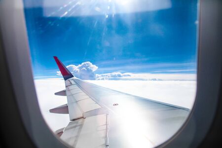 Airplane wing fly on blue sky | Trip travel business | Transportation commercialの写真素材