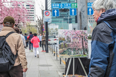 Japanese artist painting cherry blossom at street | Painter lifestyle in Tokyo Japan on 31 March 2017.のeditorial素材