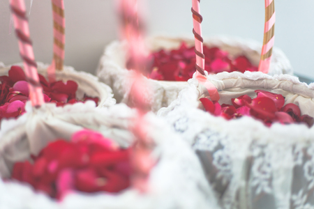 Red rose flowers in white basket for wedding dayの写真素材