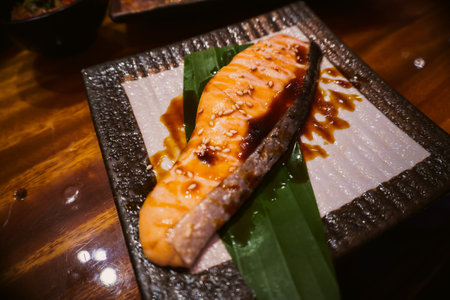 Grilled salmon with teriyaki sauce served on a plate.の写真素材