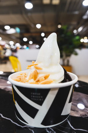 Ice cream in black and white cup on table in coffee shop.の写真素材