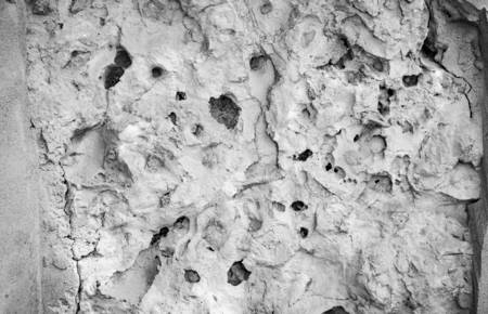 Rough piece of stone with cracks. Abstract background.
