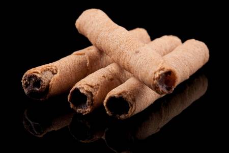 chocolatte sticks closeup on black reflective background